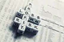 dices over newspaper, profit, loss risk