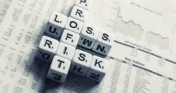 dices over newspaper, profit, loss risk