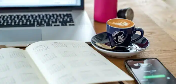 a coffee cup and a pen on a desk